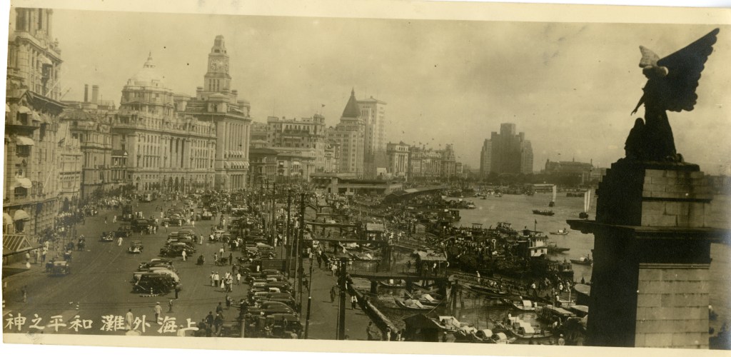 Chinese civilians and cars on Zhongshan Road at The Bund waterfront and now demolished Angel of Victory  bronze monument  with sculptor Henry C. Fehr, it featured a mournful angel with two children. The monument was removed and destroyed by Japanese forces in 1943.