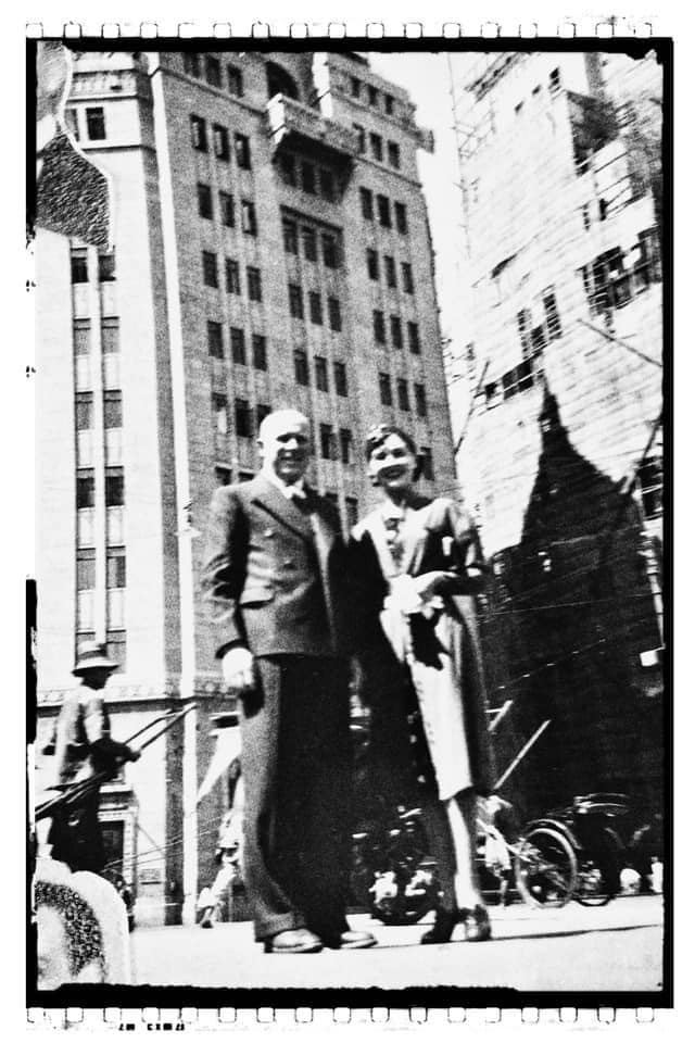 Serge first saw Xenia beneath the chrome lights of Shanghai’s Paramount Ballroom, where the dance floor glowed like a tropical aquarium and every couple seemed to move inside a private current of music.
He was holding his baton lightly, as if it were a cigarette, a conductor’s wand, a weapon against exile. She stood near the edge of the room in a dark silk dress, her hair swept into a sculptural wave, pearl earrings catching the light each time she turned her head. She had the composure of old Russia and the radiance of a woman who understood that beauty, after loss, was not vanity but defiance.
The orchestra waited.
Serge lifted his hand.
The first notes moved through the room like champagne being poured.